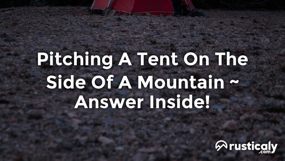 pitching a tent on the side of a mountain