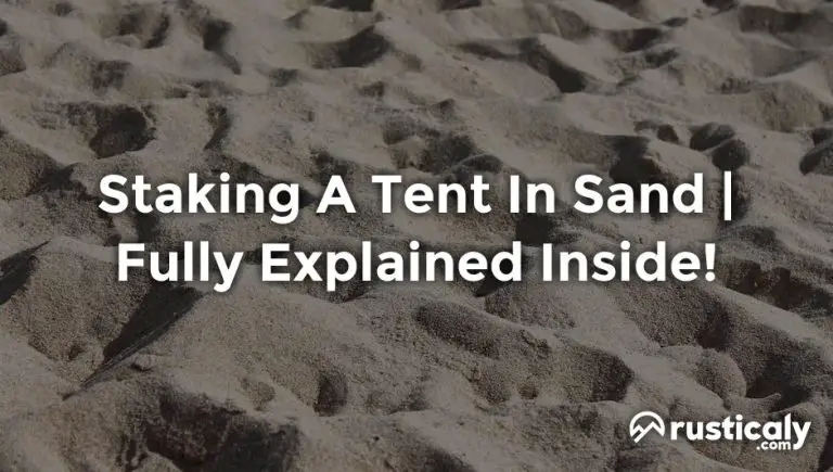 staking a tent in sand